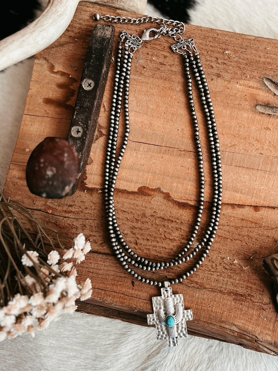 Multi-Strand Navajo Pearl Strand Necklace With A Cactus Pendant | gussieduponline